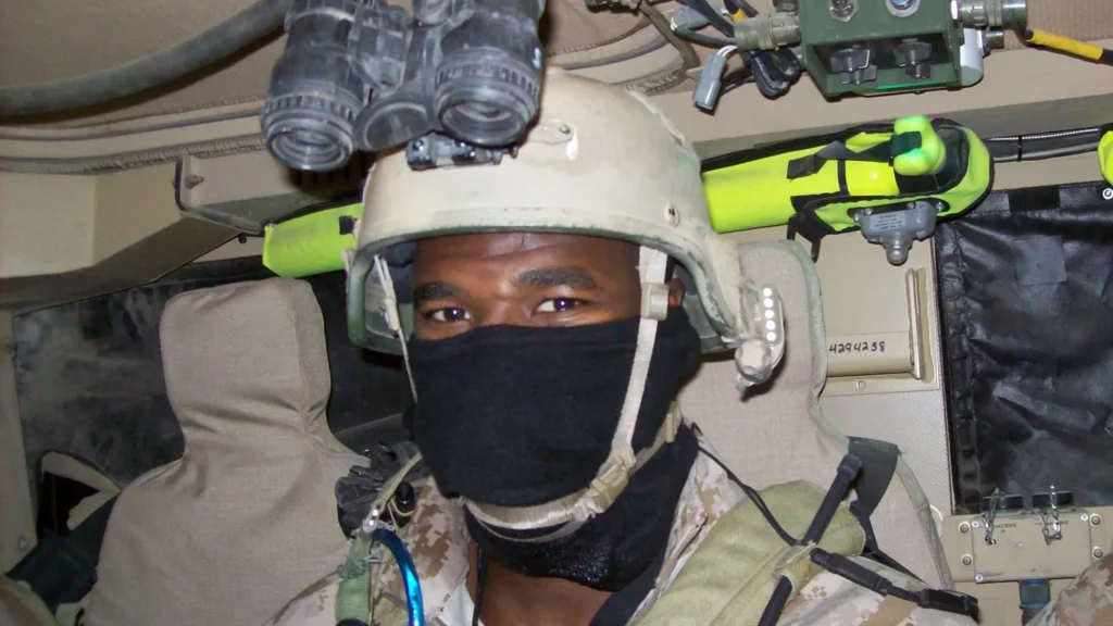 Remi as a Navy Seal, wearing a mask and combat helmet with binoculars attached.